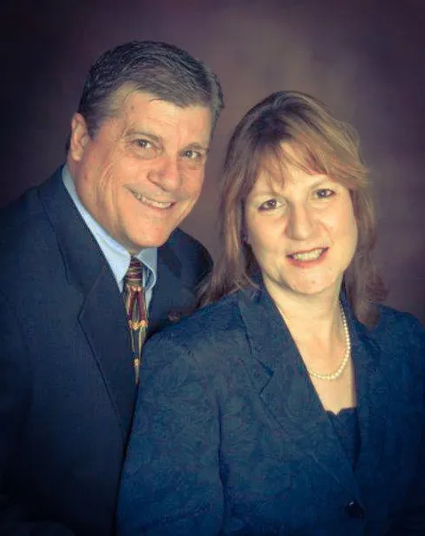 A man and woman standing next to each other.